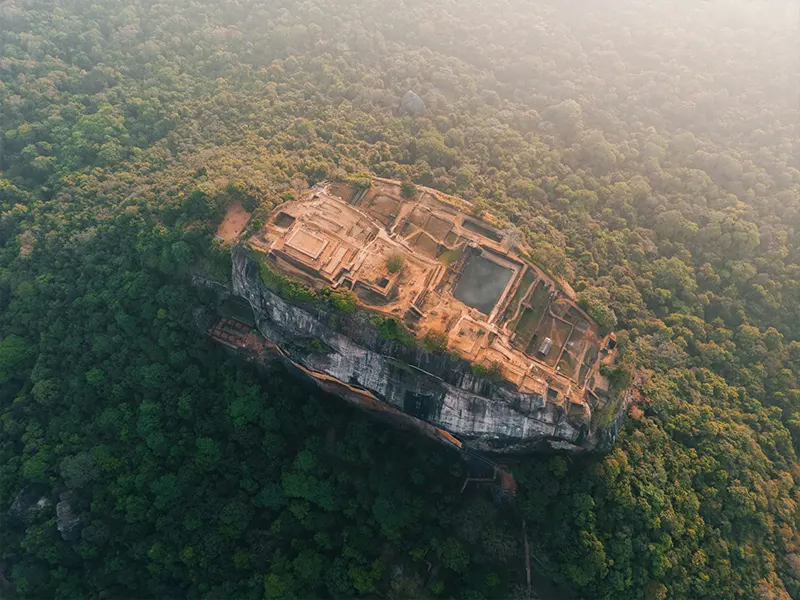 Split view of Sigiriya rock fortress and the green hills of Ella