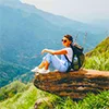 Ella surrounded by lush green mountains, tea plantations, and misty valleys.