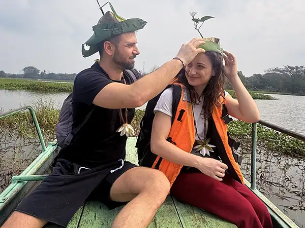 Newlyweds on a traditional village canoe ride across a tank on their rural Sri Lanka honeymoon